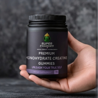 Hand holding a container of Super Charged Premium Monohydrate Creatine Gummies against a dark background