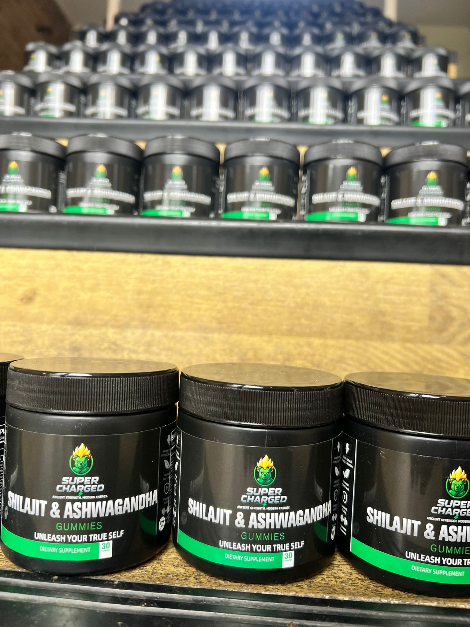 Supplement containers on a shelf with a wooden surface