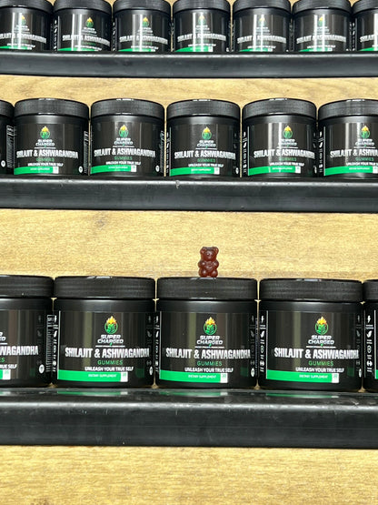 Shelf with black containers labeled 'Shilajit & Ashwagandha' on a wooden shelf.